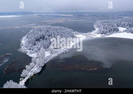 Aerial view of landscape around Cerknica lake covered in snow, frozen lake, slovenia, Europe, taken by drone Stock Photo