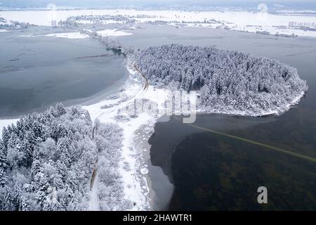 Aerial view of landscape around Cerknica lake covered in snow, frozen lake, slovenia, Europe, taken by drone Stock Photo