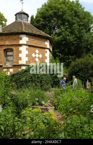 Visitors at the octagonal dovecote, dated 1641, in the gardens of Hellens Manor, Much Markle, Herts, UK Stock Photo