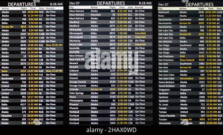 SeaTac, WA, USA - December 07, 2021; Digital departure board at Seattle Tacoma International Airport.  The flights from SeaTac are mostly on time Stock Photo