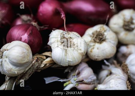 Shallow depth of field (selective focus) image with organic fresh garlic for sale in an outdoors market in Bucharest, Romania. Stock Photo