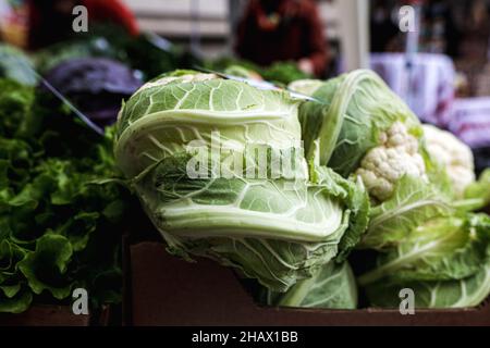 Shallow depth of field (selective focus) image with organic fresh lettuce for sale in an outdoors market in Bucharest, Romania. Stock Photo