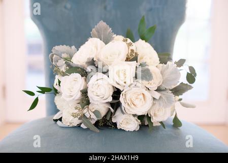 white rosses bouquet on light blue chair bridal bouquet Stock Photo