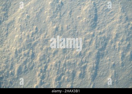 Uneven texture of snow in the sunset light. Stock Photo