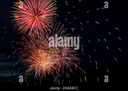 Colorful fireworks on a black background. Celebration and holidays concept. Independence Day 4th of July, New Year, festival. Bright explosions of lig Stock Photo