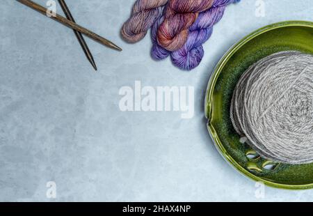 Colorful knitting yarns with accessories including needles and bowl Copy Space Stock Photo