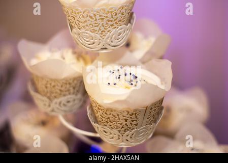 Close up of vanilla cupcake with black spinkles on cupcake tower Stock Photo