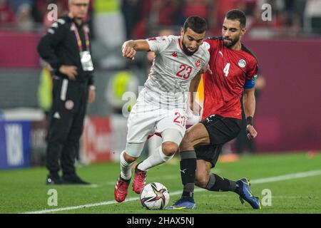 Doha, Qatar. 15th Dec, 2021. Egypt's Amr El Solia (R) and Tunisia's Naim Sliti battle for the ball during the FIFA Arab Cup semifinal soccer match between Tunisia and Egypt at Stadium 974. Credit: Ayman Aref/dpa/Alamy Live News Stock Photo
