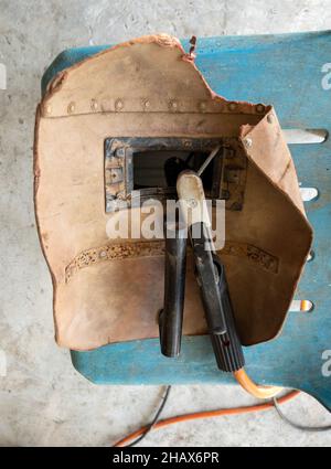 The backside of the old welding mark with the welding electrode on the plastic chair in the workplace,  front view for the copy space. Stock Photo