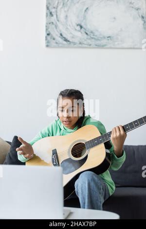 Black Teen Girl At Laptop Learning Online Sitting At Home Stock Photo ...