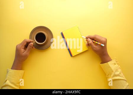 man hand writing on notepad while sited  Stock Photo
