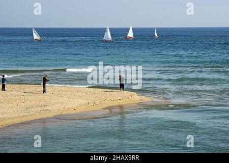 People fishing on the breakwater of the Delta del Besós, Barcelona, Catalunya, Spain, Europe Stock Photo