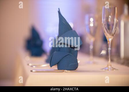 Decorative folded blue napkin on table setting Stock Photo
