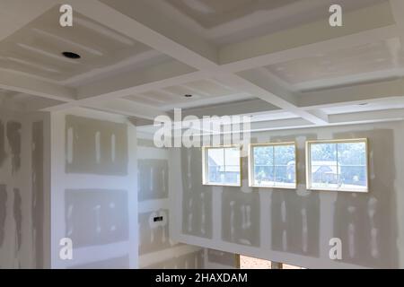 Finishing plastering drywall in ready for paint with new house Stock Photo