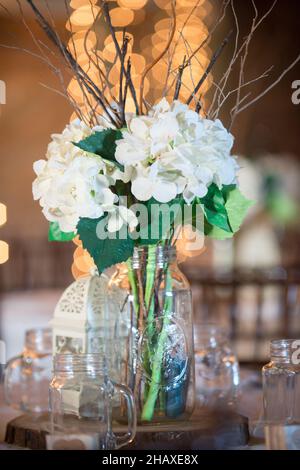 White Hydrangea Bouquet center piece with warm bokeh background at wedding reception Stock Photo