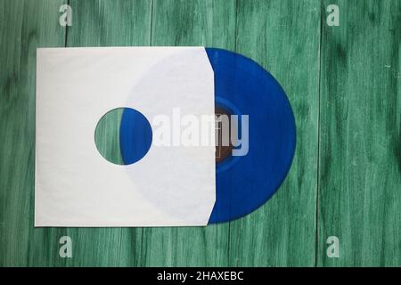 Aged White paper cover and vinyl LP record isolated on rusty background Stock Photo