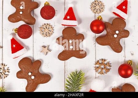 Gingerbread glazed with chocolate in shape of men between Christmas decoration Stock Photo