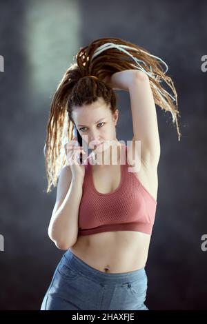 European woman with box braids speaks on phone. Stock Photo