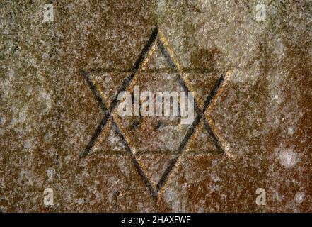 Jewish Star of David on the tombstone. Symbol of the Jews. Close up. Detail.