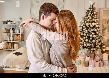 Romantic date of young couple in love on Christmas Eve. Stock Photo