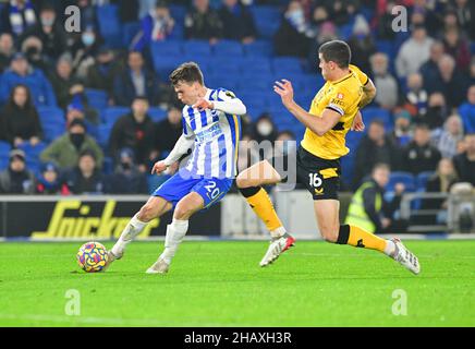Brighton, UK. 15th Dec, 2021. Solly March of Brighton and Hove Albion takes a shot on goal under pressure from Conor Coady of Wolverhampton Wanderers but put it over the bar during the Premier League match between Brighton & Hove Albion and Wolverhampton Wanderers at The Amex on December 15th 2021 in Brighton, England. (Photo by Jeff Mood/phcimages.com) Credit: PHC Images/Alamy Live News Stock Photo