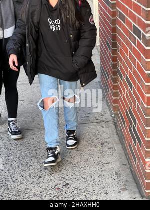 Junior High School students walk on 7th Avenue in Park Slope Brooklyn after school wearing face masks with the pandemic  continuing in November 2021. Stock Photo