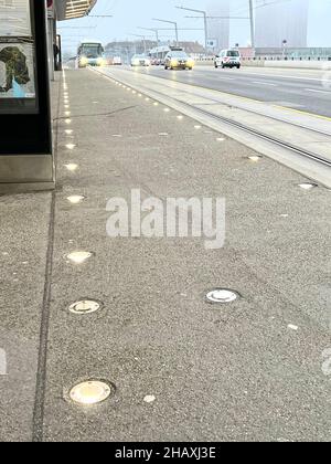 Road transportation and traffic in Zurich, Switzerland. There is a bicycle lane bordered by lights on the road to guarantee the safety to the people. Stock Photo