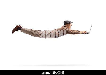 Elderly man flying and using a laptop computer isolated on white background Stock Photo