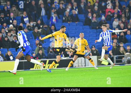 Brighton, UK. 15th Dec, 2021. Romain Saiss of Wolverhampton Wanderers gets to the ball before Solly March of Brighton and Hove Albion during the Premier League match between Brighton & Hove Albion and Wolverhampton Wanderers at The Amex on December 15th 2021 in Brighton, England. (Photo by Jeff Mood/phcimages.com) Credit: PHC Images/Alamy Live News Stock Photo