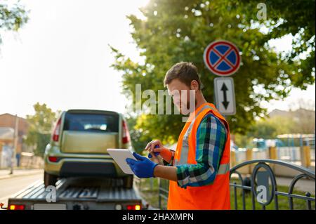 Car evacuation due to improper roadside parking Stock Photo