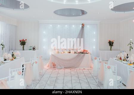Beautiful flowers on wedding table. Table set for an event party or wedding reception. Indoors wedding reception venue with décor, selective focus on Stock Photo