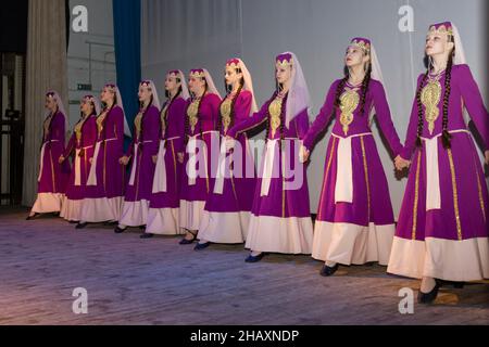 Omsk, Russia. 05 December, 2021. Ten girls in ethnic Armenian costumes dance the national Blooming cherry ritual dance. Performance of the ensemble Sa Stock Photo