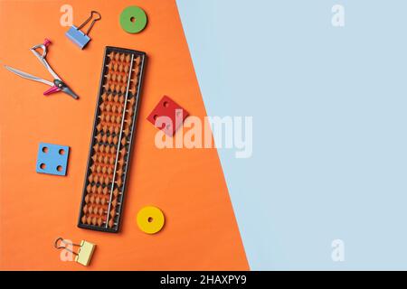 Creative lay out of mental mathematics items. Mental arithmetic for kids. School items for kids. Abacus with school supplies, drawing compass on Stock Photo