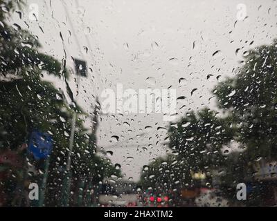 raindrops on the car window with a cloudy sky in the afternoon.  taking photos from inside the car Stock Photo
