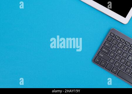 Office Workplace with Digital Gadgets Lying on Blue Table - Flat Lay Stock Photo