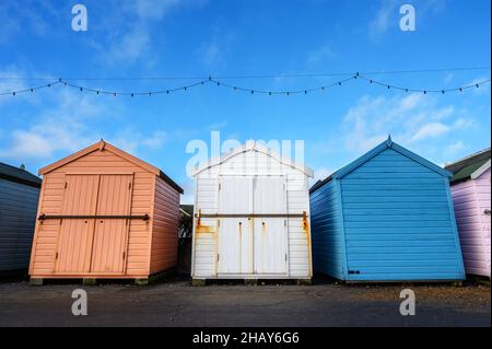 Three beach huts. These colorful beach huts are on the promenade in Felixstowe, Suffolk, UK an English resort town. Stock Photo