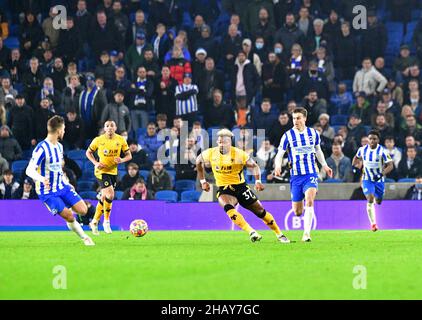 Brighton, UK. 15th Dec, 2021. Adama Traore of Wolverhampton Wanderers and Solly March of Brighton and Hove Albion chase down the ball during the Premier League match between Brighton & Hove Albion and Wolverhampton Wanderers at The Amex on December 15th 2021 in Brighton, England. (Photo by Jeff Mood/phcimages.com) Credit: PHC Images/Alamy Live News Stock Photo