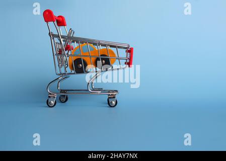 Buying car, car sales and car ownership concept. Cars in shopping trolley Stock Photo