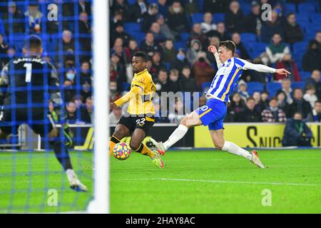 Brighton, UK. 15th Dec, 2021. Solly March of Brighton and Hove Albion makes a lunging clearance from Nelson Semedo of Wolverhampton Wanderers during the Premier League match between Brighton & Hove Albion and Wolverhampton Wanderers at The Amex on December 15th 2021 in Brighton, England. (Photo by Jeff Mood/phcimages.com) Credit: PHC Images/Alamy Live News Stock Photo