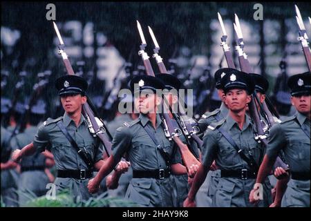 “Eyes Right” - Squad of Recruit Police Constables, Royal Hong Kong Police, on their  Passing-Out Parade, in rain, at Police Training School, Aberdeen, Hong Kong Date: 14th September 1996. This style of uniform was discontinued in the early 2000s. Stock Photo