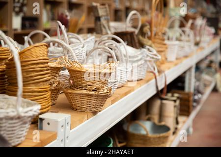 Wicker baskets on shelves in store Stock Photo