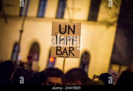 Munich, Bavaria, Germany. 15th Dec, 2021. Up to 3,500 Corona rebels, anti-vaxxers, conspiracy theorists, Reichsbuerger, neonazis, and Corona deniers assembled on Munich's Ludwigstrasse for a demonstration against a non-existent compulsory vaccination law, vaccines in general, masks and the pandemic control laws in place. Masking was extremely variable, while a large number of the masked were wearing them improperly. Distancing was nearly non-existent and there appeared to be few to no controls in place. Passersby remarked sarcastically about how the people inside 'must all have docto Stock Photo