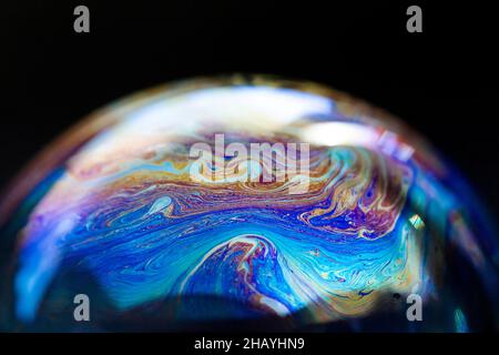 Abstract pattern, multicolored chaotic texture inside of the soap bubble, closeup Stock Photo