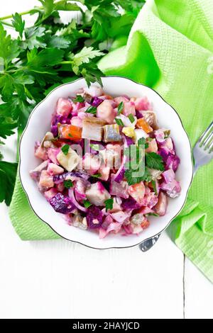 Finnish Rosoli salad with herring, beetroot, potatoes, pickled or pickled cucumbers, carrots, onions and eggs, dressed with mayonnaise in a bowl again Stock Photo