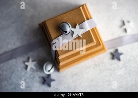 Overhead view of three gift boxes with a ribbon and Christmas bells and star shape decorations Stock Photo