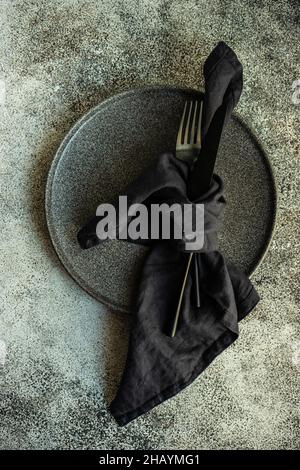 Cutlery tied in a napkin on a plate Stock Photo