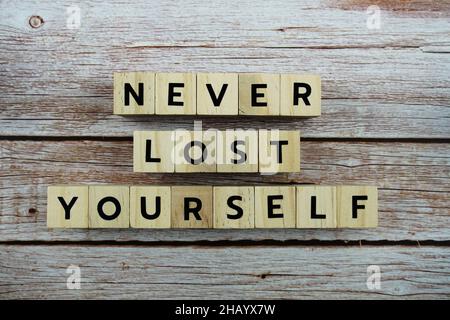 Never Lost Yourself word alphabet letters on wooden background Stock Photo