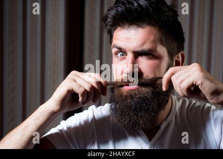 Funny man with long moustache. Bearded man with mustache, bearded gay. Barbershop concept. Mustache men. Stock Photo