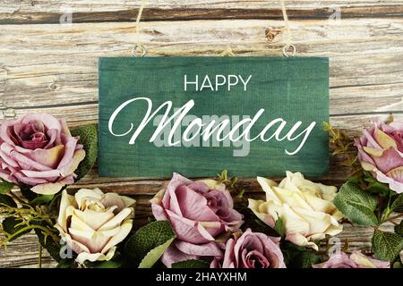 Happy Monday typography text with roses flowers bouquet on wooden background Stock Photo