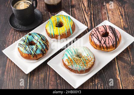 Delicious donuts decorated with different decorations on wooden table Stock Photo